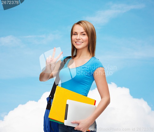 Image of female student with bag, tablet pc and folders