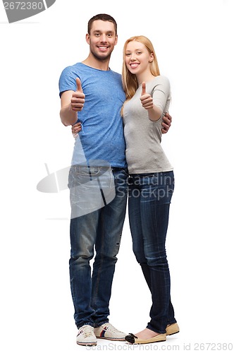 Image of smiling couple showing thumbs up