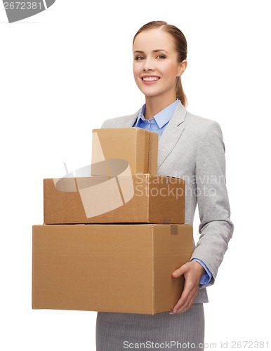 Image of smiling businesswoman holding cardboard boxes