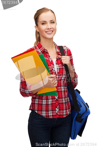 Image of smiling female student with bag and folders