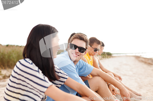 Image of group of friends or volleyball team on the beach