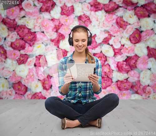 Image of young woman in casual clothes sitting on floor