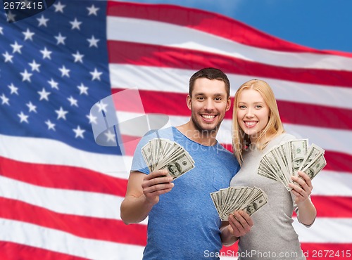 Image of smiling couple holding dollar cash money