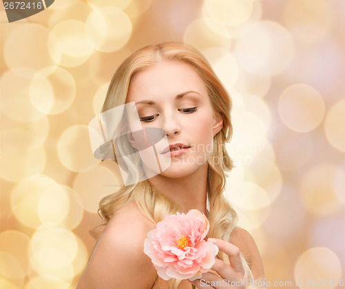 Image of lovely woman with peony flower