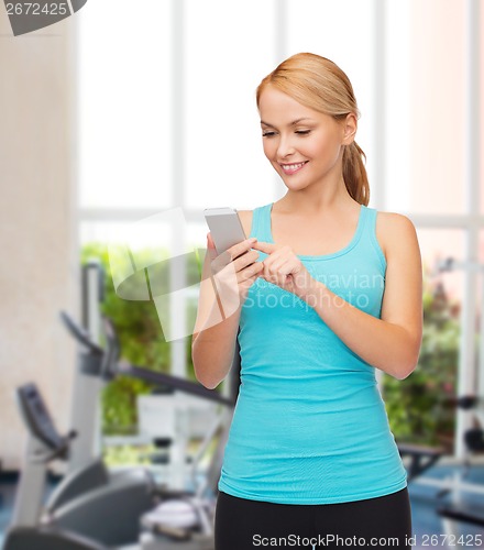 Image of sporty woman with smartphone