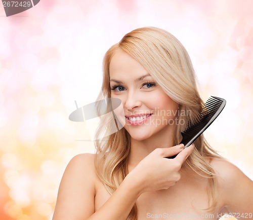 Image of smiling woman with hair brush