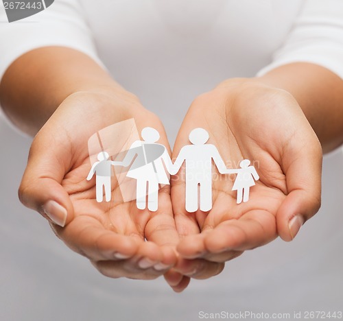 Image of womans hands with paper man family