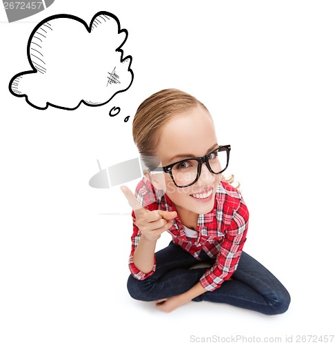 Image of smiling teenager in eyeglasses with finger up