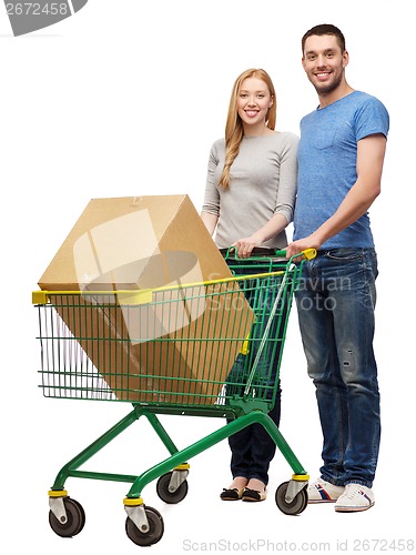 Image of smiling couple with shopping cart and big box