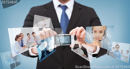 Image of businessman with smartphone and news on screen