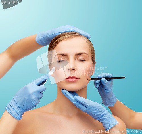 Image of woman face and beautician hands with pencil