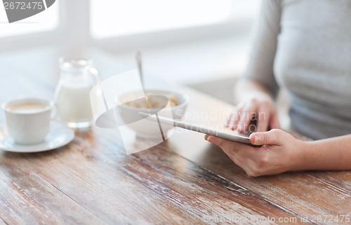 Image of close up of woman reading news from tablet pc