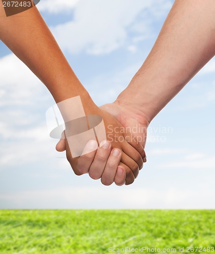 Image of woman and man holding hands