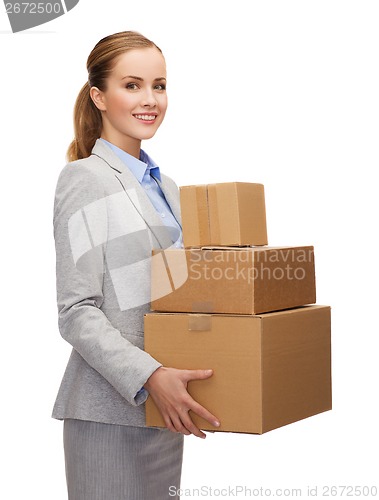 Image of smiling businesswoman holding cardboard boxes