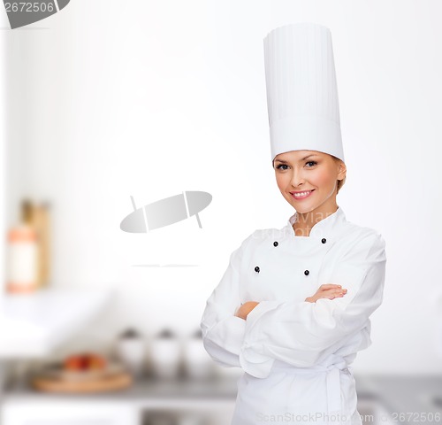 Image of smiling female chef with crossed arms