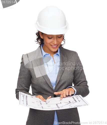 Image of businesswoman in white helmet with blueprint