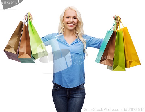 Image of smiling woman with many shopping bags