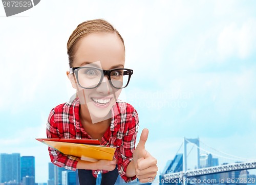 Image of student in glasses with folders showing thumbs up