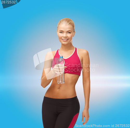 Image of smiling woman with bottle of water