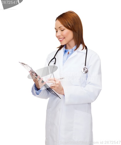 Image of smiling female doctor with clipboard