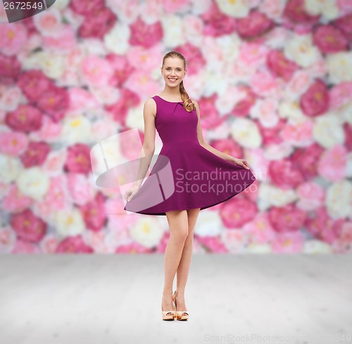 Image of young woman in purple dress and high heels