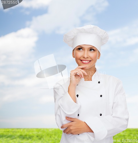 Image of smiling female chef dreaming