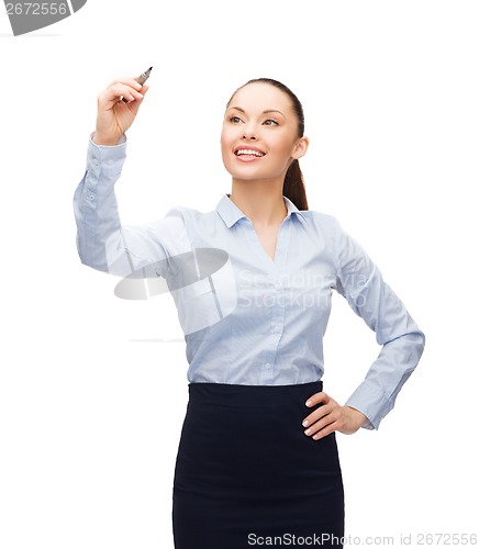 Image of businesswoman writing in the air with marker