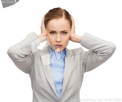 Image of stressed businesswoman with covered ears