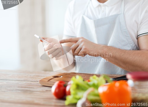 Image of closeup of man pointing finger to smartphone