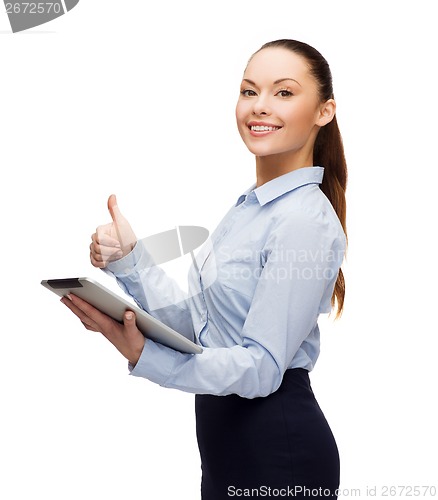 Image of smiling woman looking at tablet pc computer