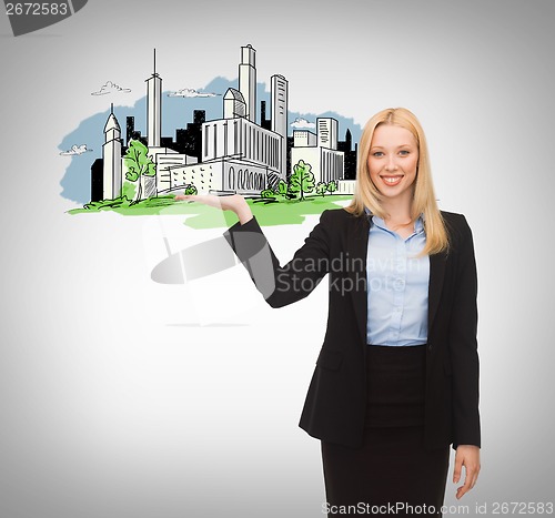 Image of smiling woman showing city sketch on her hand