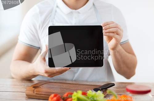 Image of close up of male hands holding tablet pc