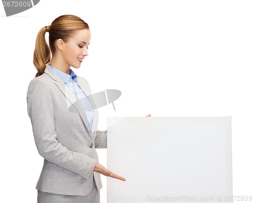 Image of smiling businesswoman with white blank board