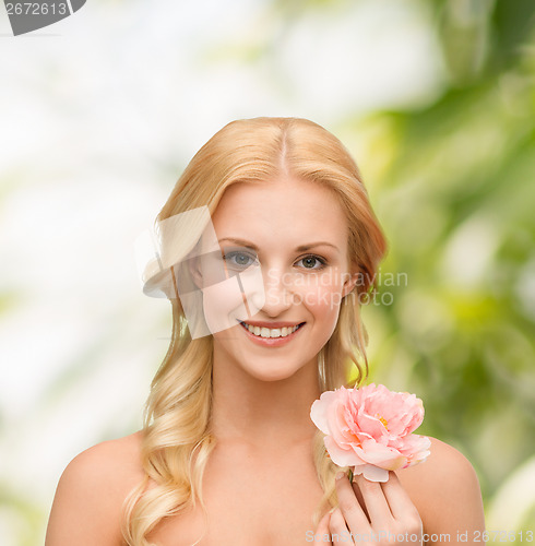 Image of smiling woman with peony flower