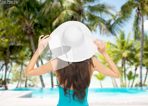 Image of model in swimsuit with hat