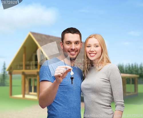 Image of smiling couple holding keys