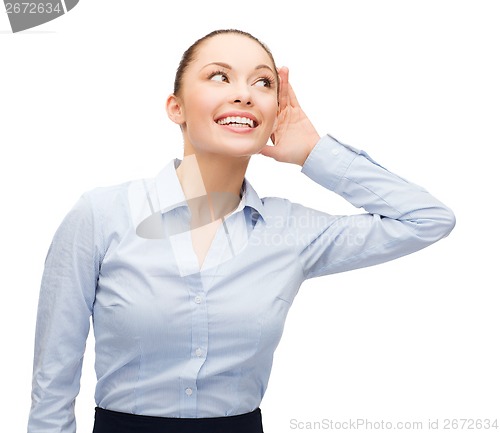 Image of smiling businesswoman listening gossig