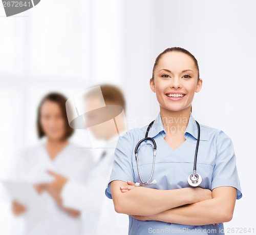 Image of smiling female doctor or nurse with stethoscope