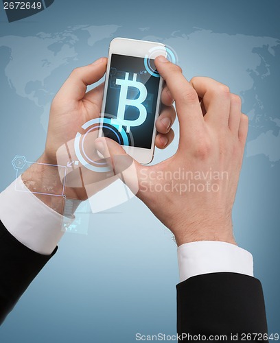 Image of businessman touching screen of smartphone