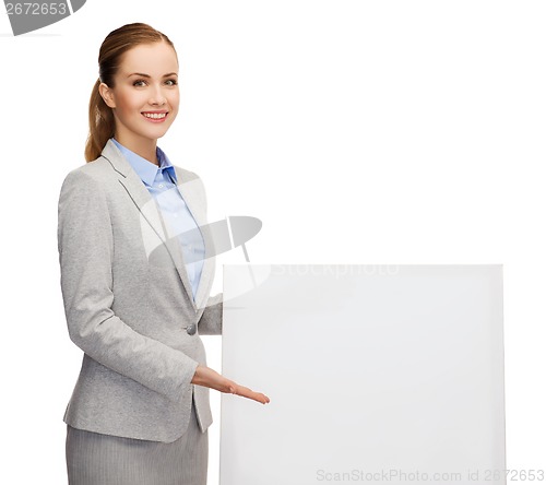 Image of smiling businesswoman with white blank board