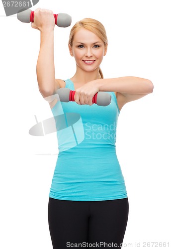 Image of young sporty woman with light dumbbells