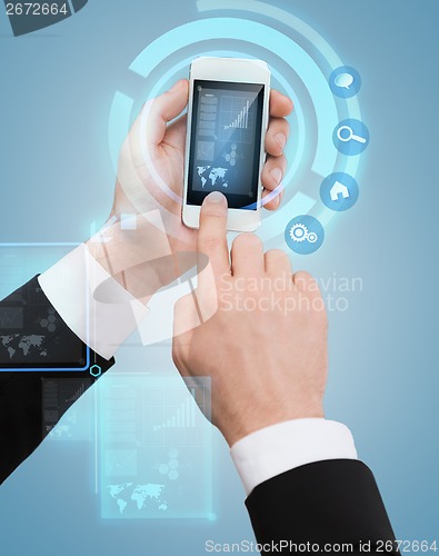 Image of businessman touching screen of smartphone