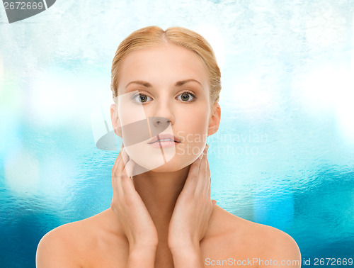Image of beautiful woman touching her face skin