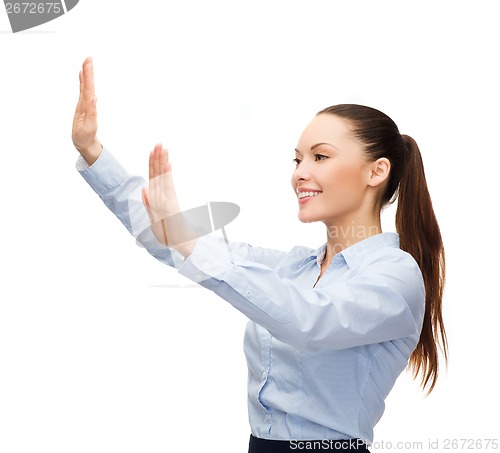 Image of smiling businesswoman pointing to something