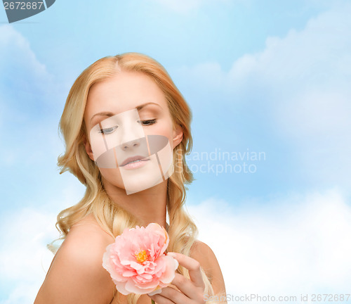 Image of lovely woman with peony flower