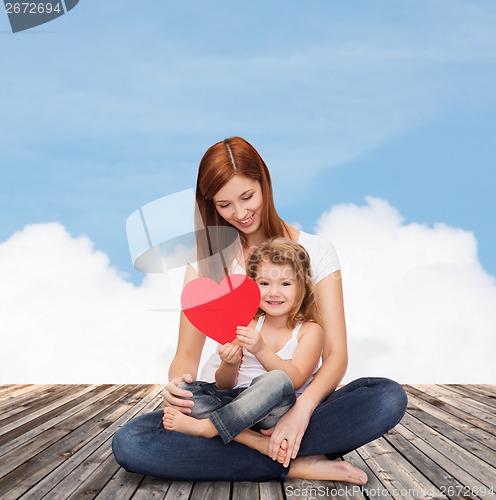 Image of happy mother with adorable little girl and heart