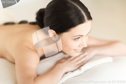 Image of woman in spa with hot stones