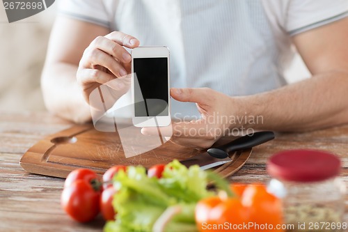 Image of close up of male hands holding smartphone