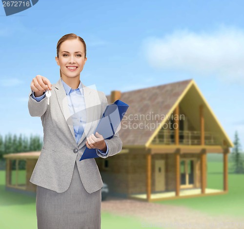 Image of smiling businesswoman with folder and keys