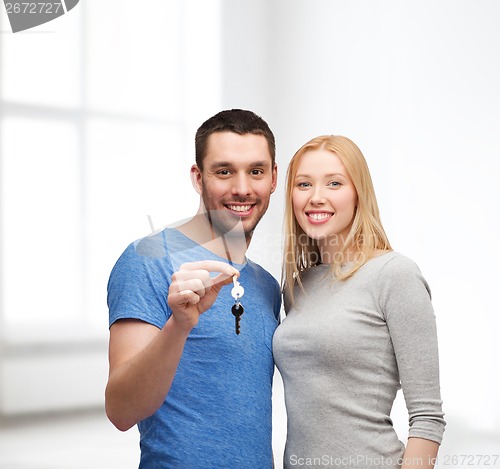 Image of smiling couple holding keys